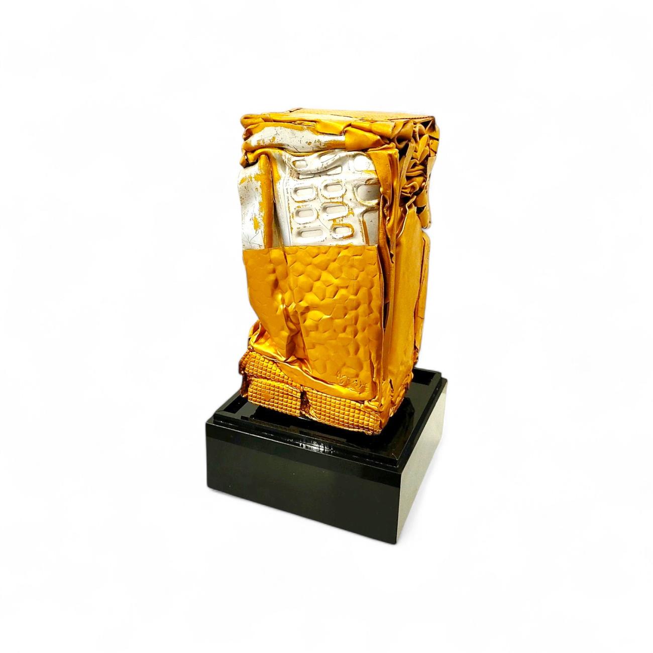 Compression GUIGOZ en aluminium doré et argenté de César, sur socle noir.